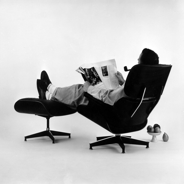 Charles Eames posing in the Lounge Chair, photo for an advertisement, 1956 © Eames Office LLC